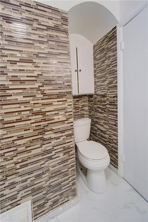 3624 Norledge Ave, Kansas City, MO 64123 - bathroom featuring marble finish flooring and tile walls
