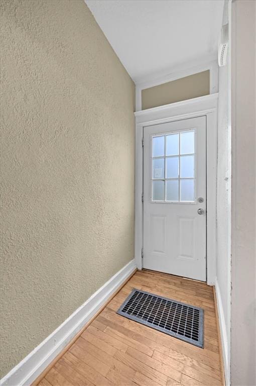 319 Market St, Leavenworth, KS 66048 - doorway to outside with a textured wall and wood finished floors