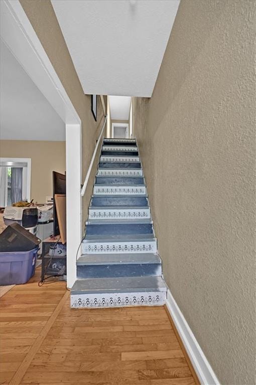 319 Market St, Leavenworth, KS 66048 - stairs featuring a textured wall and wood finished floors