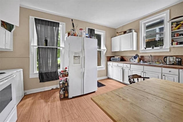 319 Market St, Leavenworth, KS 66048 - kitchen featuring white appliances, white cabinetry, and light wood-style floors