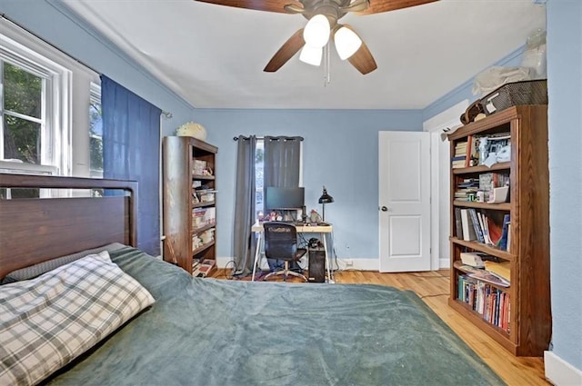 319 Market St, Leavenworth, KS 66048 - bedroom with multiple windows, wood finished floors, and a ceiling fan