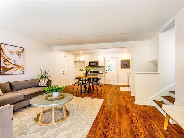10013 Benson St, Overland Park, KS 66212 - living area featuring dark wood-style floors, stairway, and recessed lighting