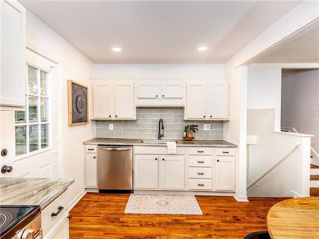 10013 Benson St, Overland Park, KS 66212 - kitchen with stainless steel appliances, dark wood finished floors, backsplash, white cabinetry, and recessed lighting