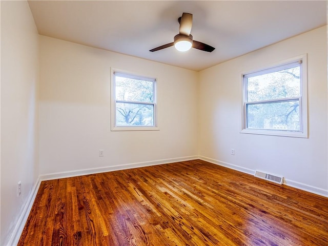 10013 Benson St, Overland Park, KS 66212 - empty room featuring plenty of natural light, wood finished floors, and a ceiling fan