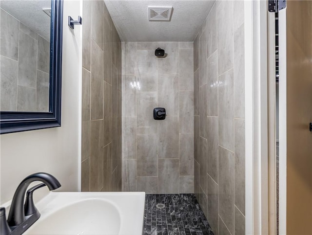 10013 Benson St, Overland Park, KS 66212 - full bath with tiled shower and a textured ceiling