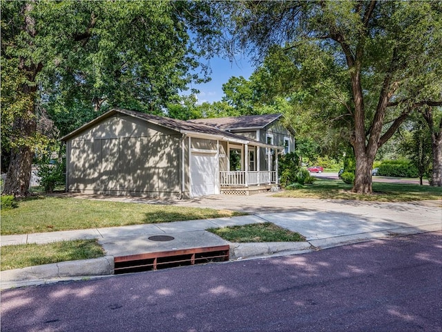 10013 Benson St, Overland Park, KS 66212 - view of front of house with an attached garage, concrete driveway, and a front lawn