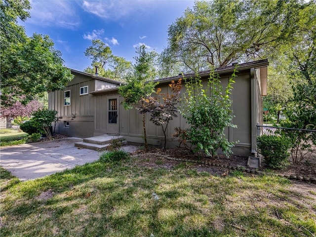 10013 Benson St, Overland Park, KS 66212 - rear view of property featuring board and batten siding and a patio area