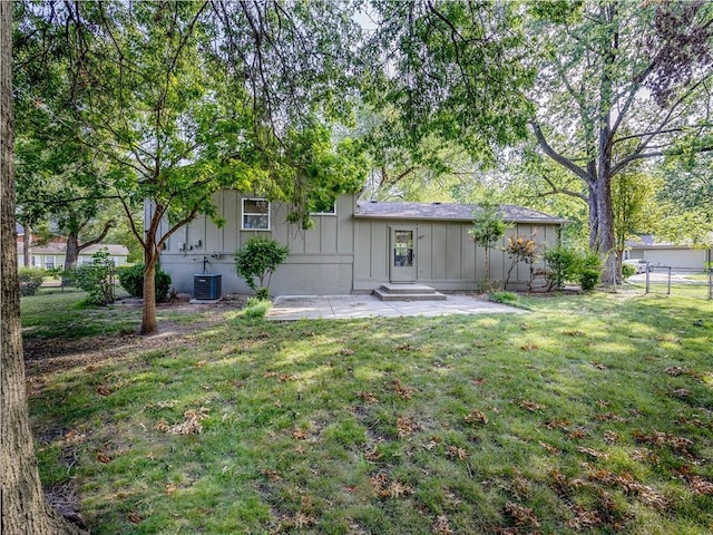 10013 Benson St, Overland Park, KS 66212 - back of house featuring board and batten siding and a patio area