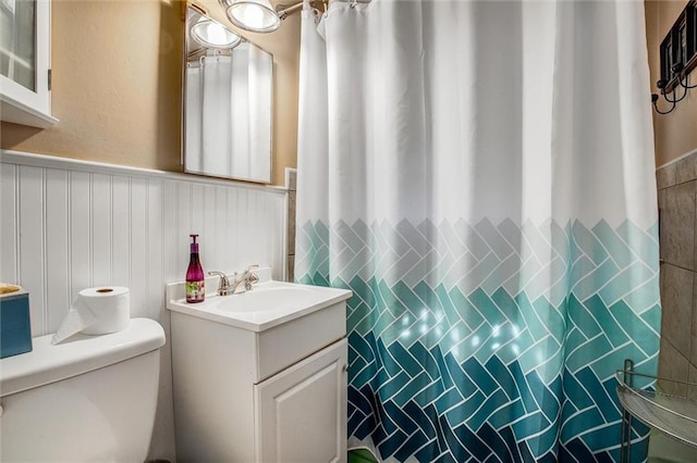 3021 Appleton Ave, Independence, MO 64052 - full bathroom with vanity, a wainscoted wall, and a shower with curtain