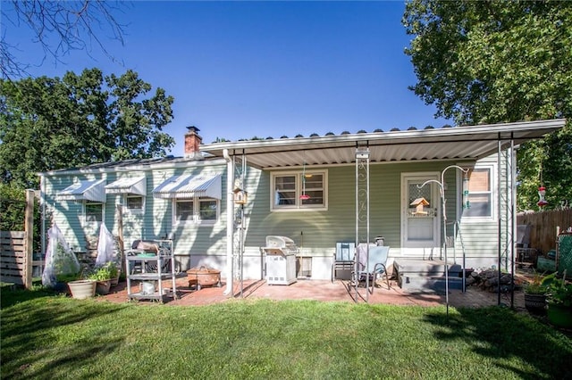 3021 Appleton Ave, Independence, MO 64052 - rear view of house featuring a yard and a chimney