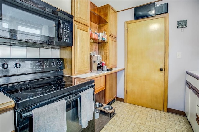 3021 Appleton Ave, Independence, MO 64052 - kitchen with black appliances, light flooring, and light countertops