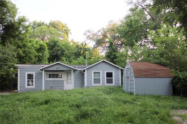 5610 Miami Ave, Kansas City, KS 66106 - view of front of home featuring a storage unit, a front lawn, and view of scattered trees