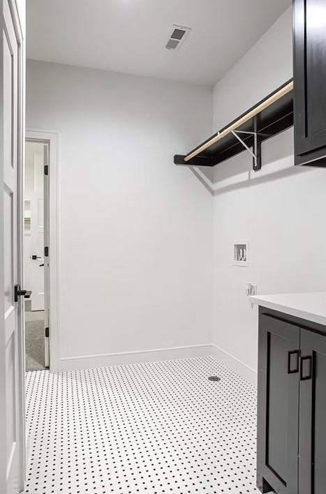 3409 W 187th St, Overland Park, KS 66085 - laundry room featuring cabinet space and hookup for a washing machine