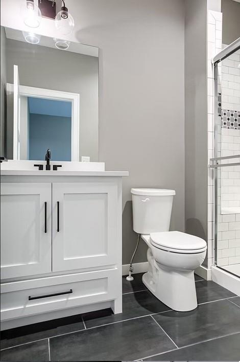 3409 W 187th St, Overland Park, KS 66085 - full bathroom featuring a stall shower, tile patterned flooring, and vanity