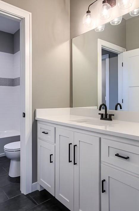 3409 W 187th St, Overland Park, KS 66085 - bathroom with vanity, tile patterned floors, and shower / bathtub combination