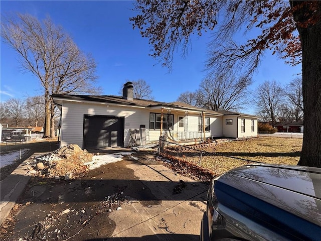 3649 S Park Ave, Independence, MO 64052 - view of front of home with a chimney, an attached garage, and driveway