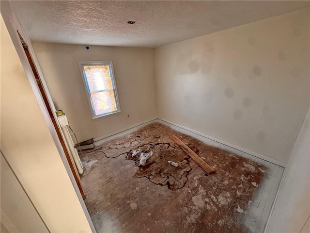 3649 S Park Ave, Independence, MO 64052 - spare room featuring a textured ceiling and baseboards
