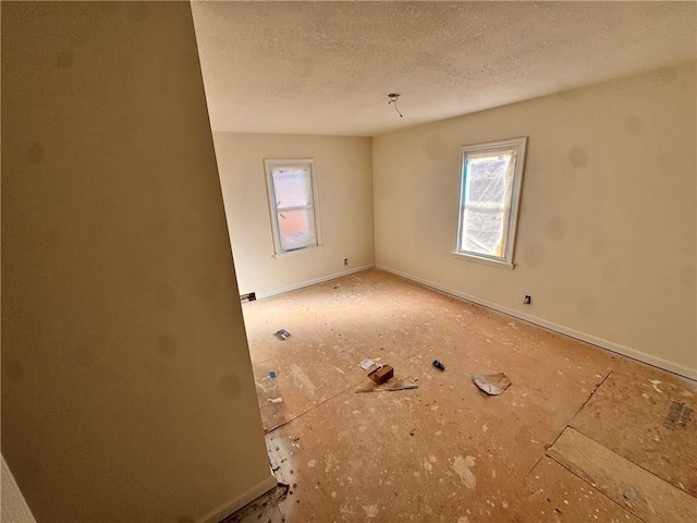 3649 S Park Ave, Independence, MO 64052 - unfurnished room with plenty of natural light and a textured ceiling