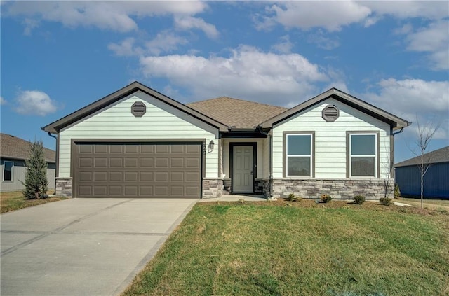 4712 SE 5th St, Blue Springs, MO 64014 - ranch-style house featuring stone siding, an attached garage, concrete driveway, and a front yard