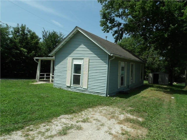 604 S Lexington St, Holden, MO 64040 - view of property exterior with a storage shed and a yard