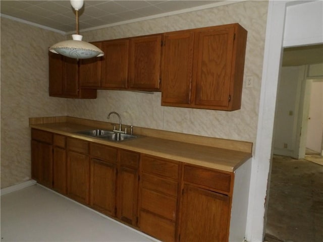 604 S Lexington St, Holden, MO 64040 - kitchen with brown cabinetry, light countertops, and wallpapered walls