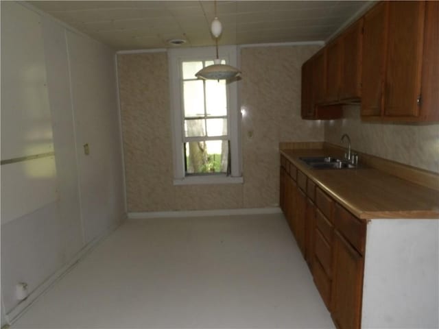 604 S Lexington St, Holden, MO 64040 - kitchen featuring light carpet, brown cabinets, and light countertops