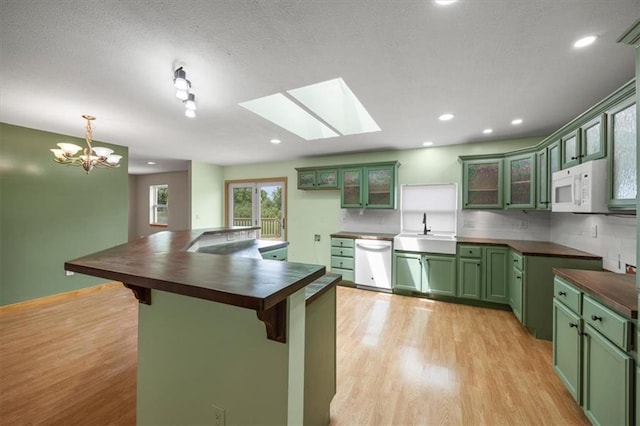 295 E 2300th Rd, Edgerton, KS 66021 - kitchen featuring green cabinets, white appliances, light wood-type flooring, a kitchen breakfast bar, and a chandelier