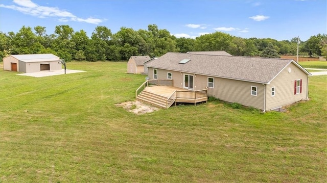 295 E 2300th Rd, Edgerton, KS 66021 - back of house with an outdoor structure, a deck, and a lawn