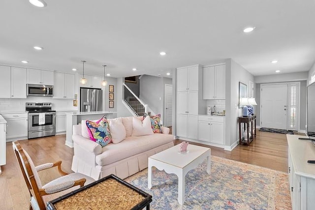 3726 SW Walsh Dr, Lees Summit, MO 64082 - living room featuring light wood-type flooring, stairway, and recessed lighting