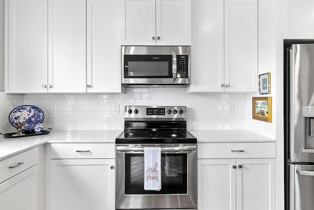 3726 SW Walsh Dr, Lees Summit, MO 64082 - kitchen with stainless steel appliances, light countertops, and white cabinetry