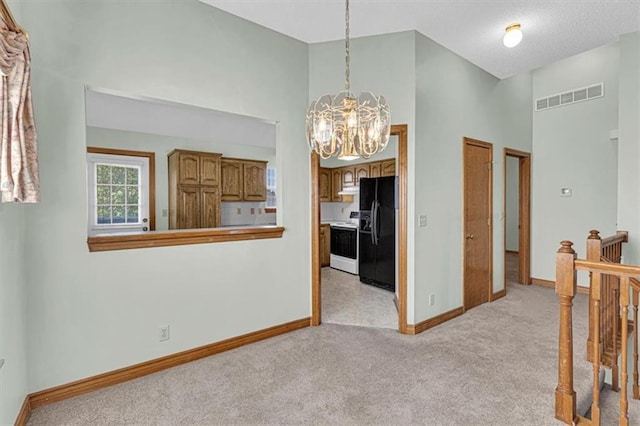 21213 W 51st Ter, Shawnee, KS 66218 - hall featuring a chandelier, light colored carpet, and an upstairs landing