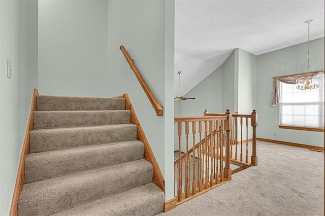 21213 W 51st Ter, Shawnee, KS 66218 - stairway with carpet, a textured ceiling, a chandelier, and a ceiling fan