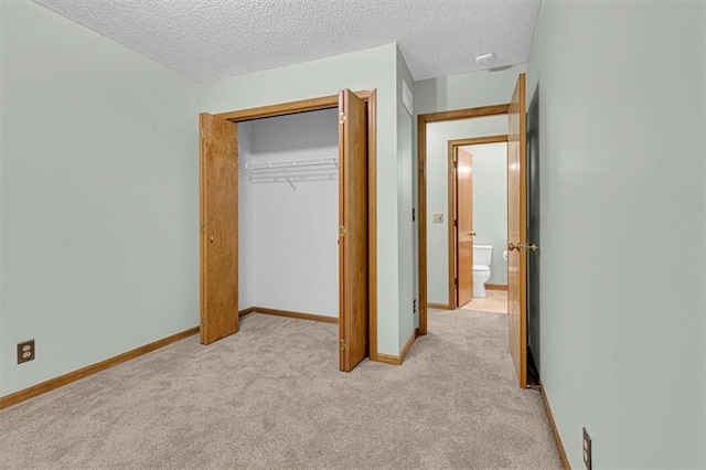 21213 W 51st Ter, Shawnee, KS 66218 - unfurnished bedroom featuring light colored carpet, a closet, and a textured ceiling