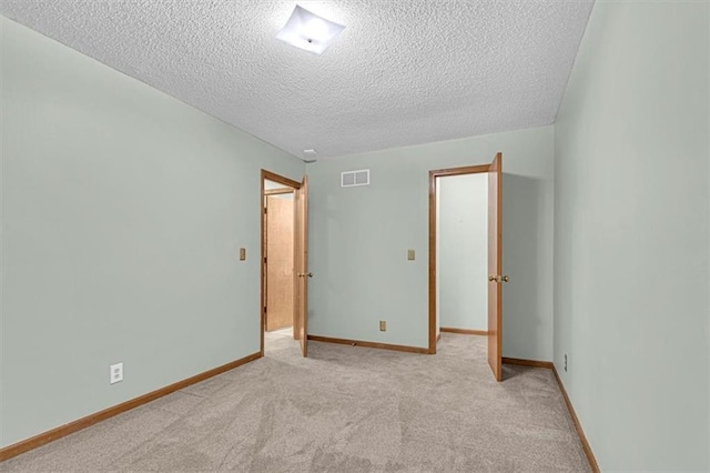 21213 W 51st Ter, Shawnee, KS 66218 - unfurnished room with a textured ceiling and light colored carpet