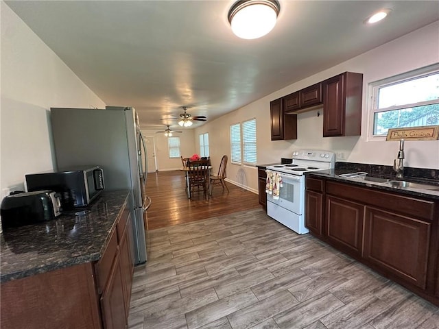 3009 N 33rd St, Kansas City, KS 66104 - kitchen featuring white electric range oven, a ceiling fan, healthy amount of natural light, light wood-type flooring, and recessed lighting