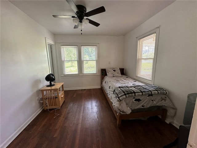 3009 N 33rd St, Kansas City, KS 66104 - bedroom featuring dark wood-style floors, multiple windows, and a ceiling fan