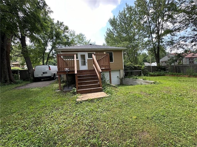 3009 N 33rd St, Kansas City, KS 66104 - back of house with an attached garage, a wooden deck, and stairway