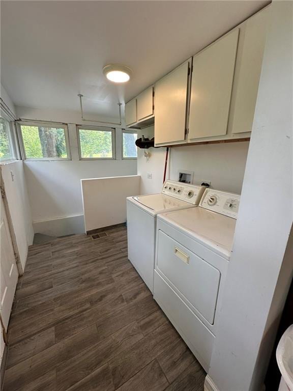 3009 N 33rd St, Kansas City, KS 66104 - washroom featuring cabinet space, washing machine and dryer, and dark wood-style floors