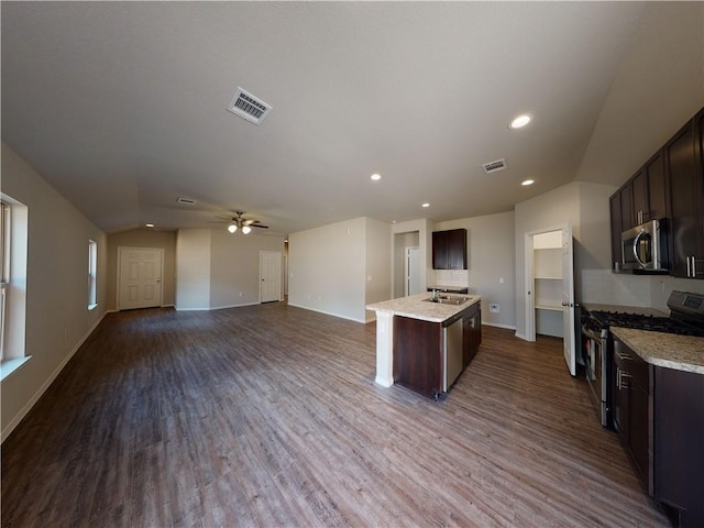 591 W Lanesfield St, Gardner, KS 66030 - kitchen featuring stainless steel appliances, lofted ceiling, dark brown cabinets, open floor plan, and recessed lighting