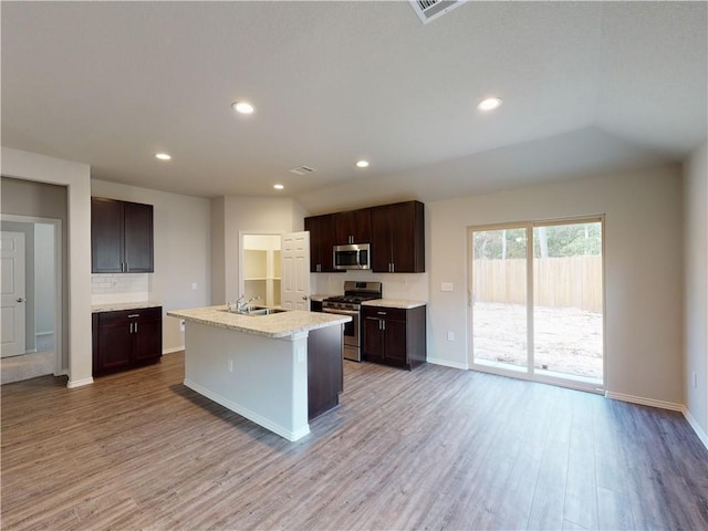591 W Lanesfield St, Gardner, KS 66030 - kitchen featuring appliances with stainless steel finishes, wood finished floors, light countertops, dark brown cabinetry, and recessed lighting