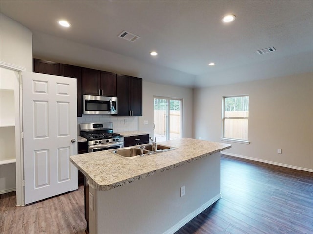 591 W Lanesfield St, Gardner, KS 66030 - kitchen with appliances with stainless steel finishes, light countertops, light wood finished floors, backsplash, and recessed lighting
