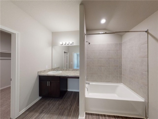 591 W Lanesfield St, Gardner, KS 66030 - bathroom featuring shower / bathtub combination, vanity, and wood finished floors