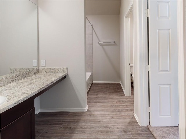 591 W Lanesfield St, Gardner, KS 66030 - bathroom featuring vanity, wood finished floors, and shower / tub combination