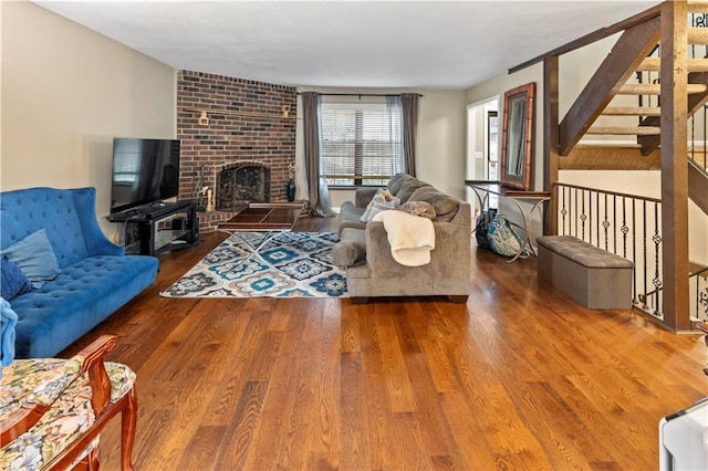 27 W Bannister Rd, Kansas City, MO 64114 - living room featuring wood finished floors, stairway, and a fireplace