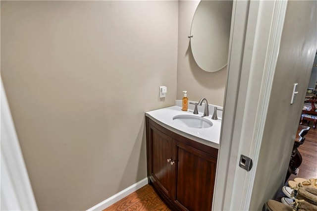 27 W Bannister Rd, Kansas City, MO 64114 - half bathroom with vanity and wood finished floors
