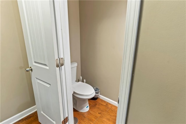 27 W Bannister Rd, Kansas City, MO 64114 - bathroom featuring toilet and wood finished floors