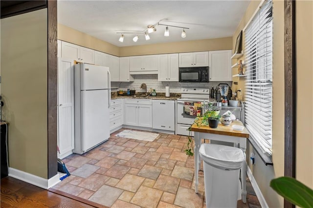 27 W Bannister Rd, Kansas City, MO 64114 - kitchen with white appliances, white cabinets, decorative backsplash, and light stone finish flooring