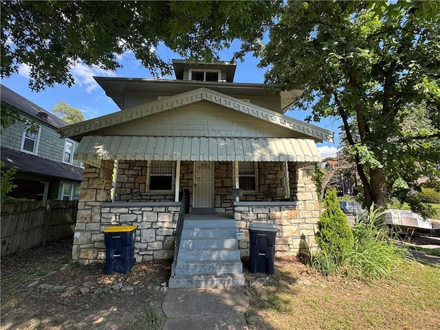 5647 Wayne Ave, Kansas City, MO 64110 - american foursquare style home with stone siding and a porch