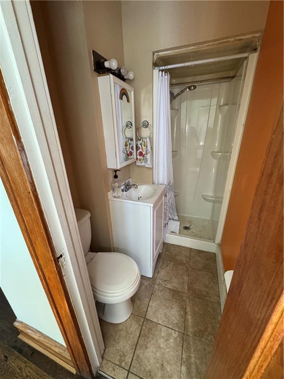 5647 Wayne Ave, Kansas City, MO 64110 - full bath featuring a shower stall and tile patterned floors