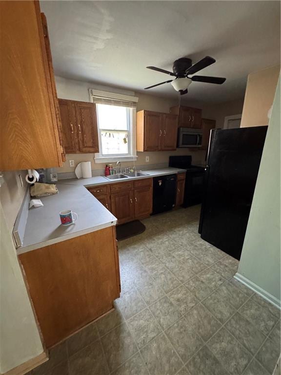 5647 Wayne Ave, Kansas City, MO 64110 - kitchen featuring black appliances, ceiling fan, light countertops, and brown cabinets